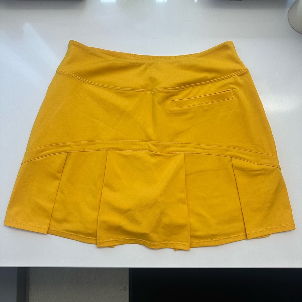 TWO SKORTS — bundle of NWOT red  and EUC yellow tennis or golf skirts